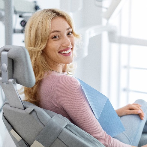 Woman smiling while sitting in treatment chair