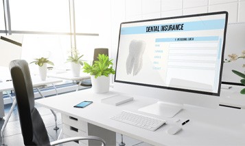 A man calculating the cost of dental crowns with a calculator, coins, and a tooth model