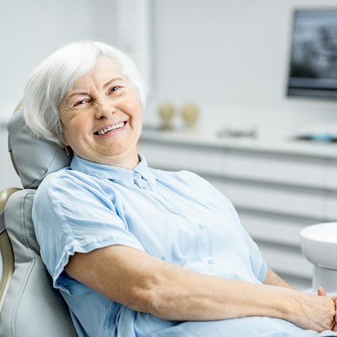 Senior woman sitting in dental chair smiling
