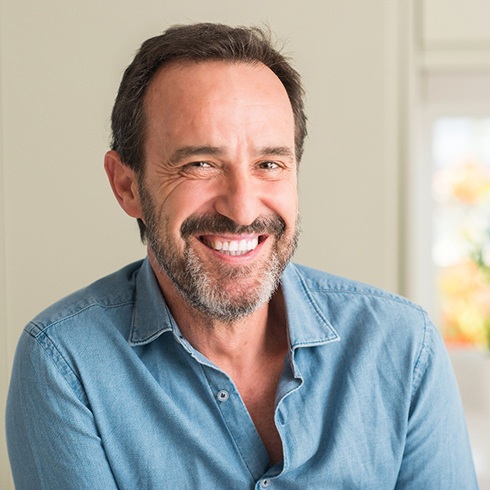 Man with beard sitting and smiling