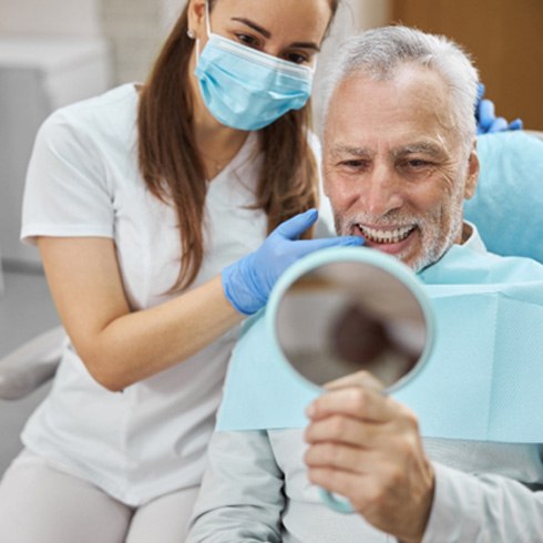 An older man happy with his new dental implants