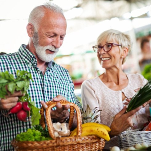 An elderly couple shopping for healthy foods