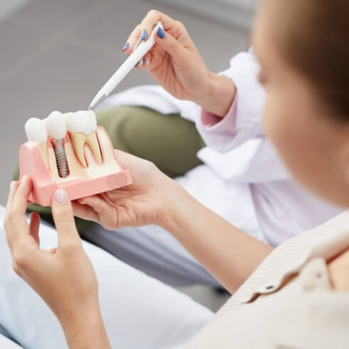 Dentist explaining the cost of dental implants