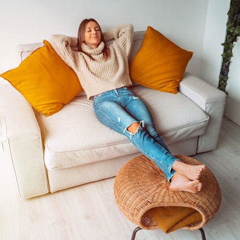 Woman resting on her sofa at home