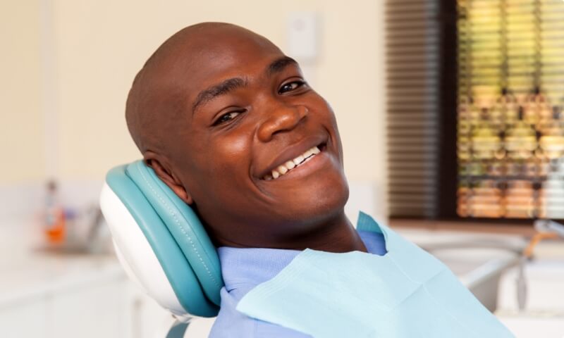 Smiling man in dental chair during preventive dentistry visit