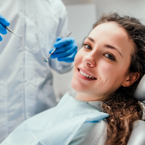 Woman receiving dental checkup and teeth cleaning visit