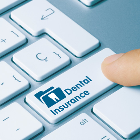 Close-up of key on keyboard reading “dental insurance”