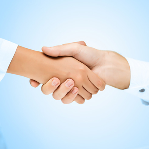 Close-up of dentist and patient shaking hands