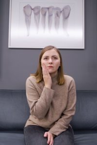 Woman with toothache at emergency dentist