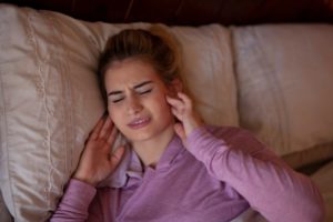 a woman clenching her jaw in her sleep