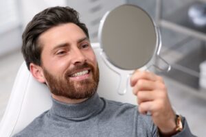 man with a beard looking at his new smile